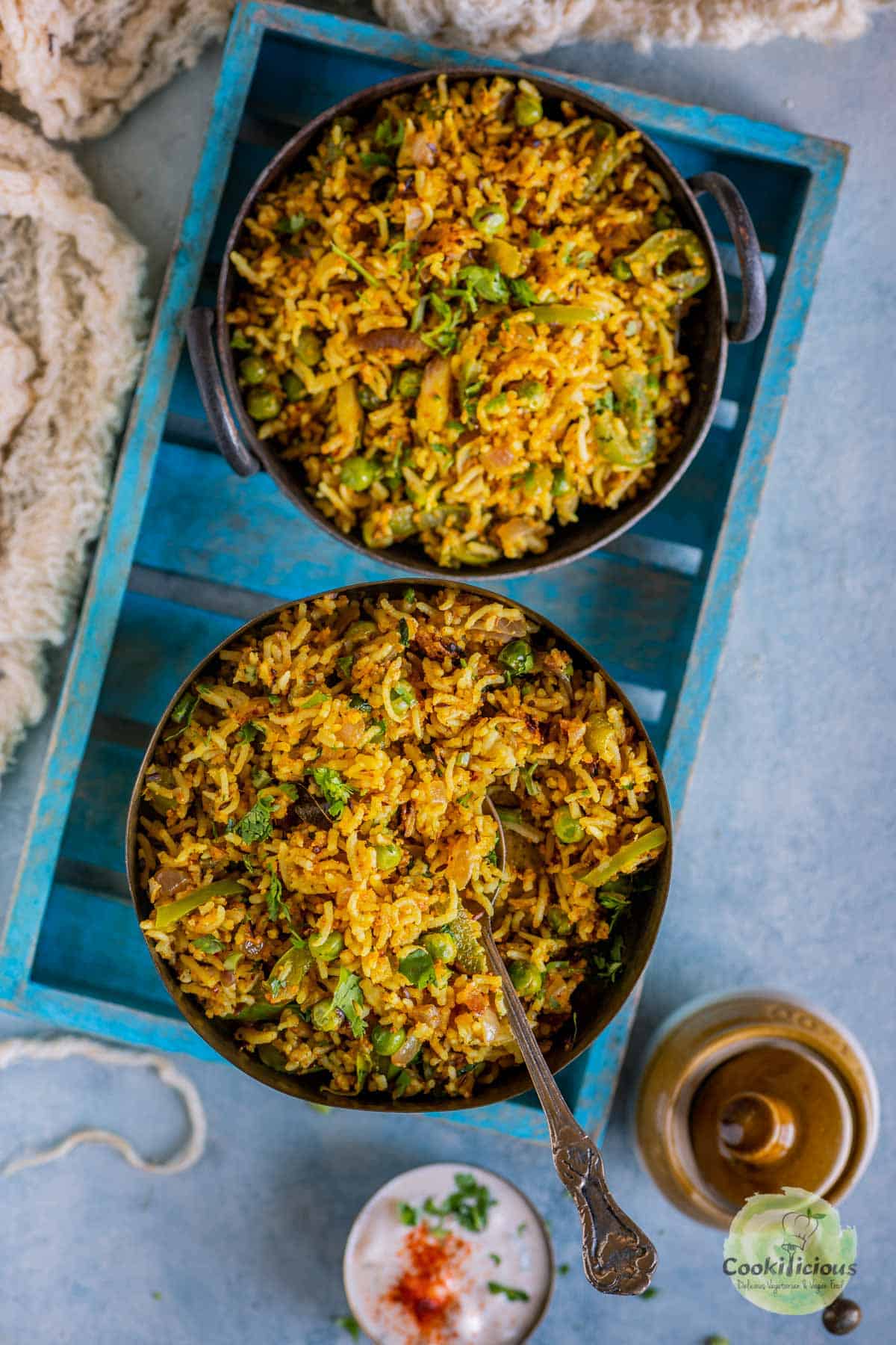 2 bowls of capsicum rice served in a tray