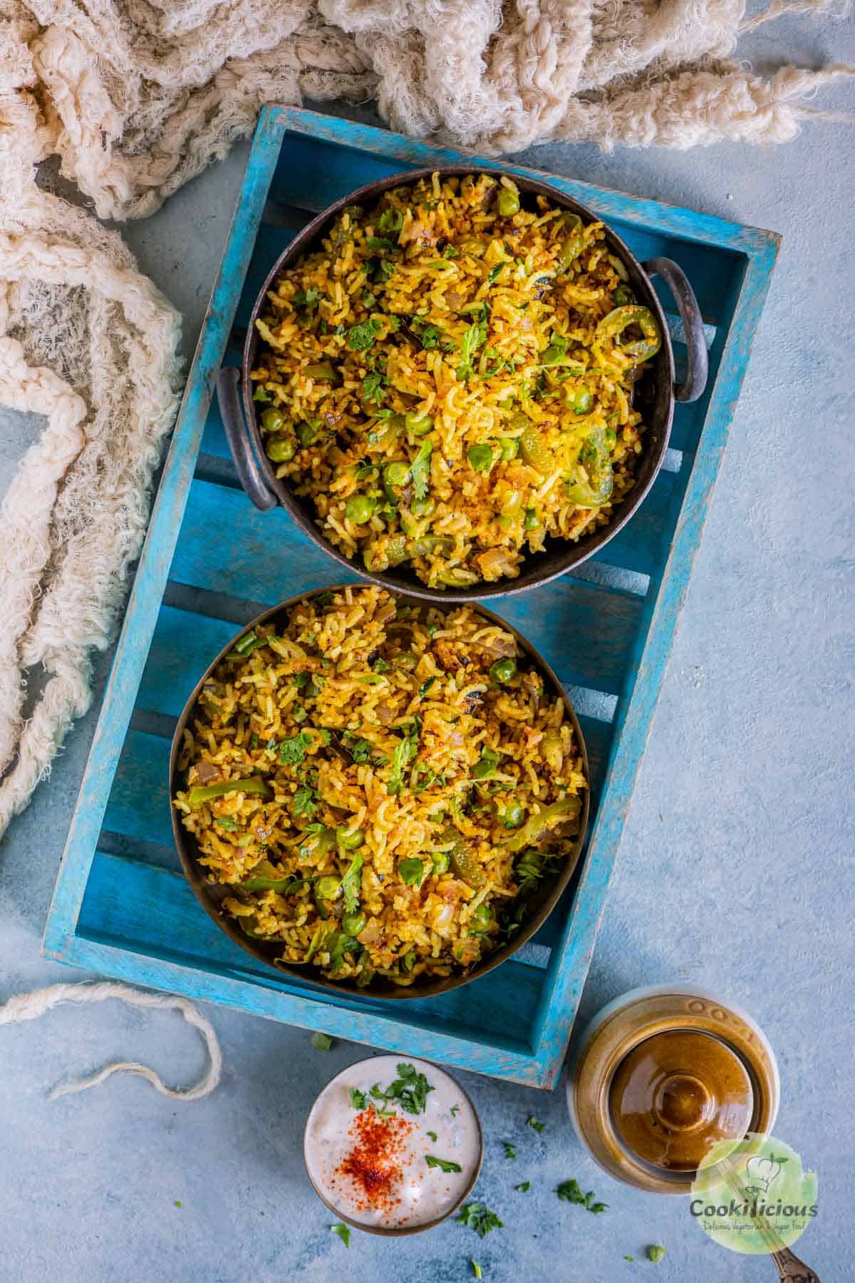 Bell Pepper Fried Rice | Capsicum Rice served in 2 bowls that are placed in a blue tray
