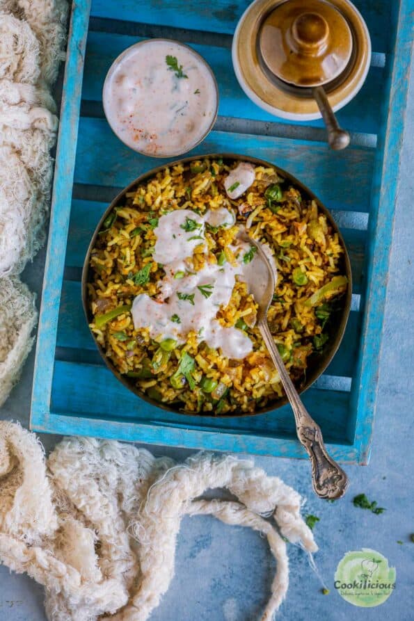Bell Pepper Fried Rice served in a bowl with raita on top