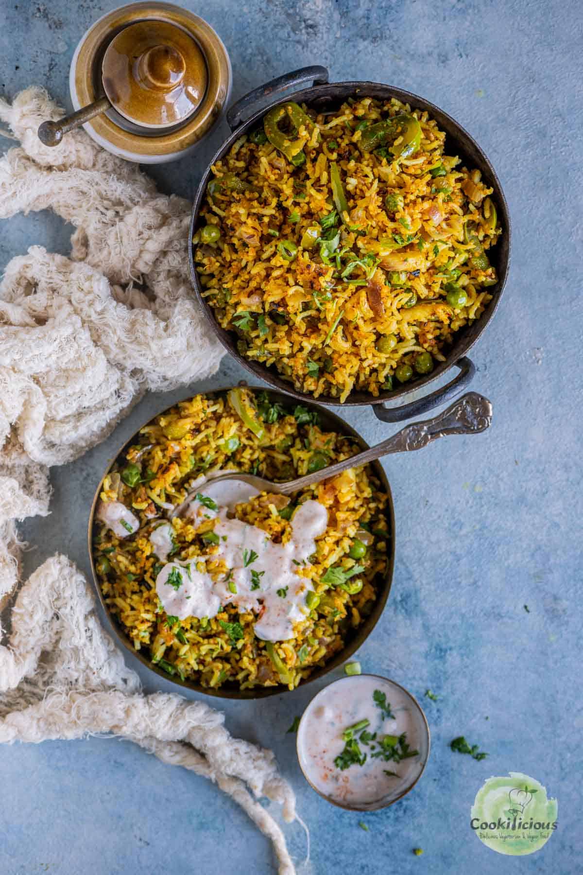 2 bowls of Bell Pepper Fried Rice with raita on one of them