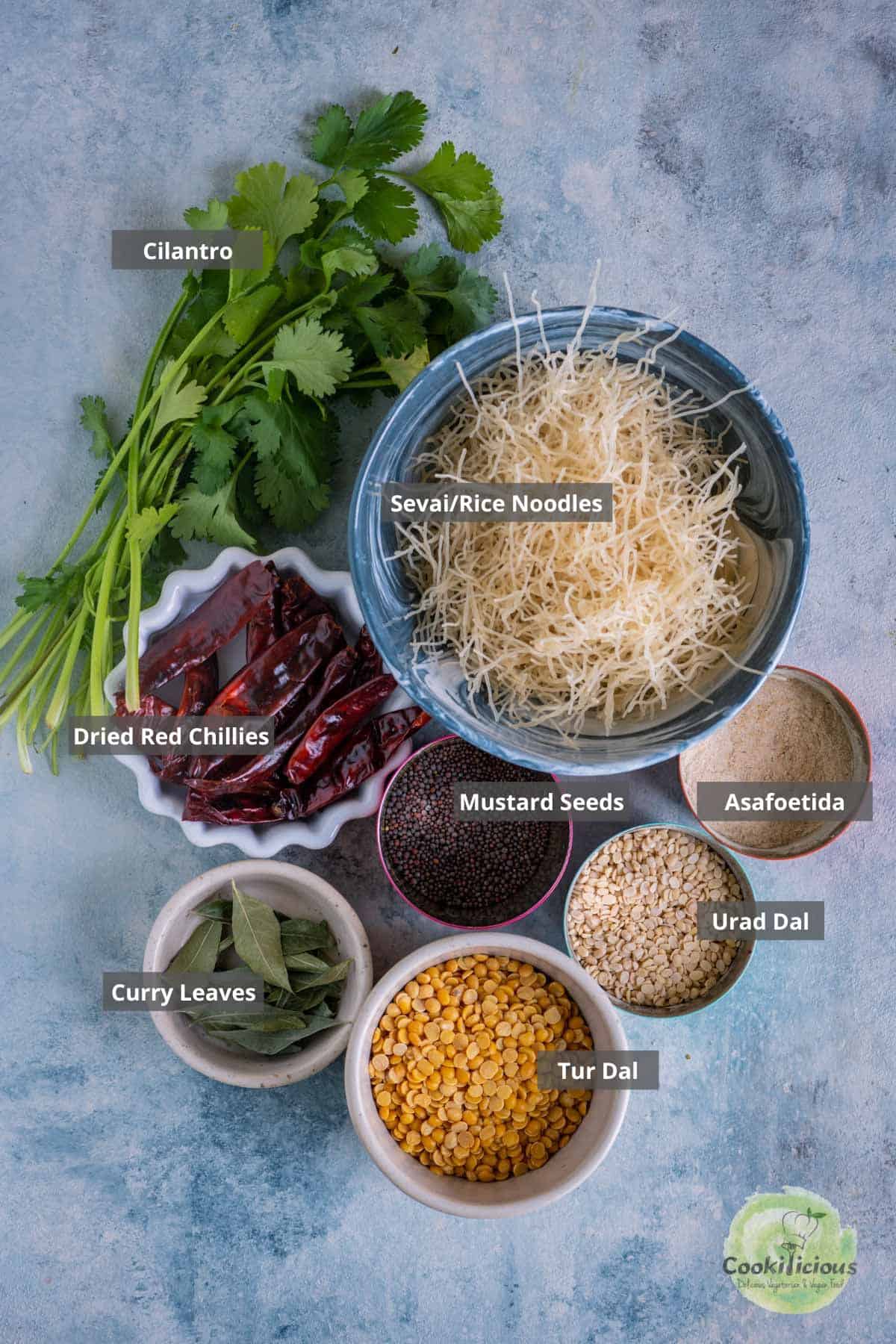 all the ingredients needed to make Paruppu Sevai placed on a table with labels on them