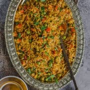 Freshly made South Indian Capsicum Rice served in an oval platter.