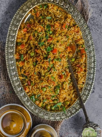 Freshly made South Indian Capsicum Rice served in an oval platter.