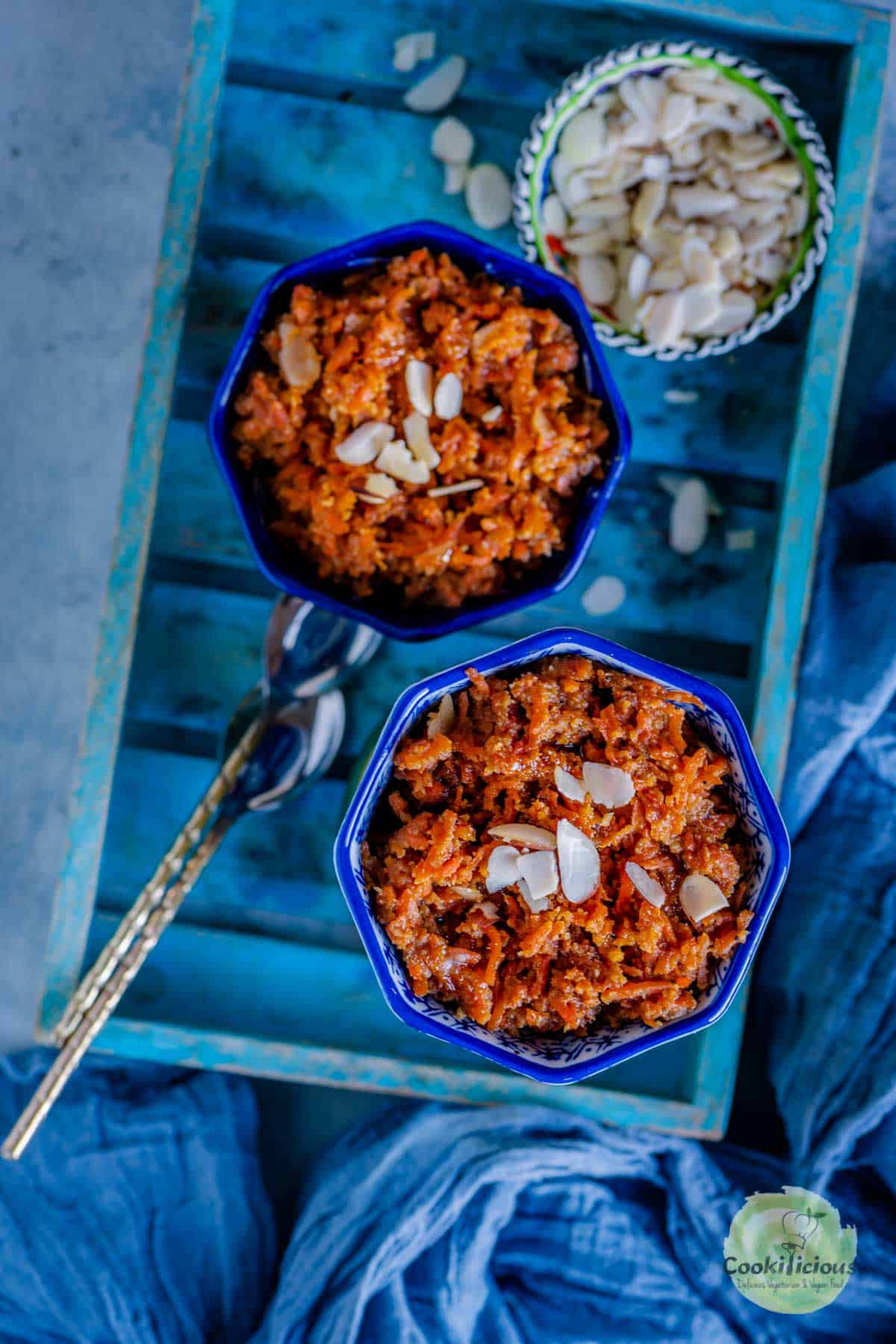 2 bowls of carrot halwa served in a a blue tray