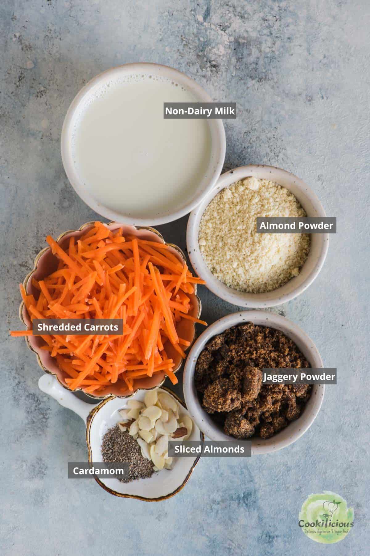 all the ingredients needed to make Instant Pot Vegan Carrot Halwa placed on a table with labels on them