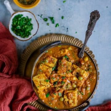 Mutter Paneer served in a bowl with a spoon