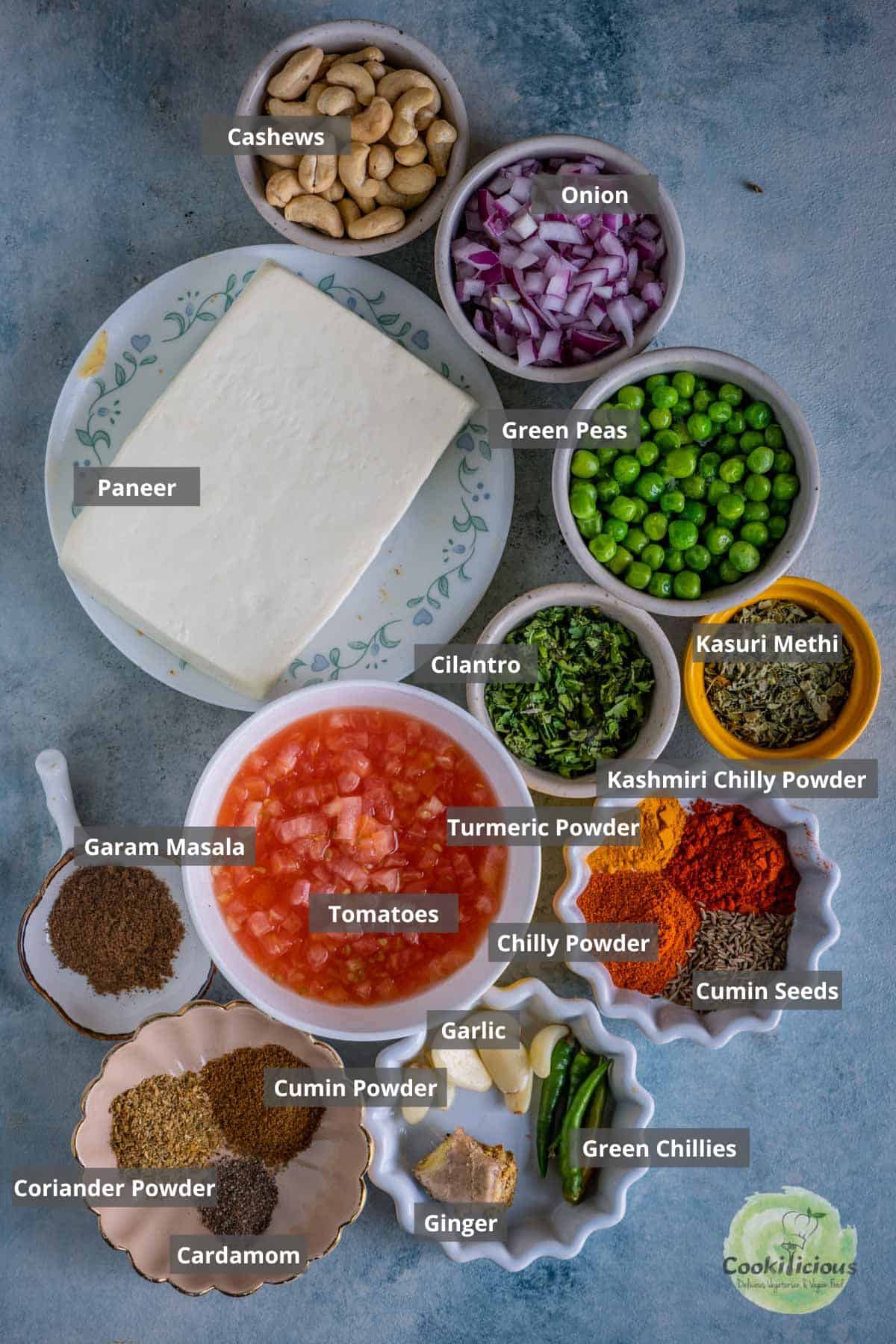 all the ingredients needed to make Mutter Paneer placed on a table with labels on them
