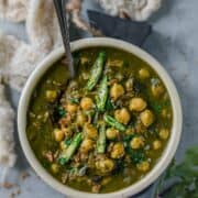 Chana Palak served in a bowl with a spoon in it