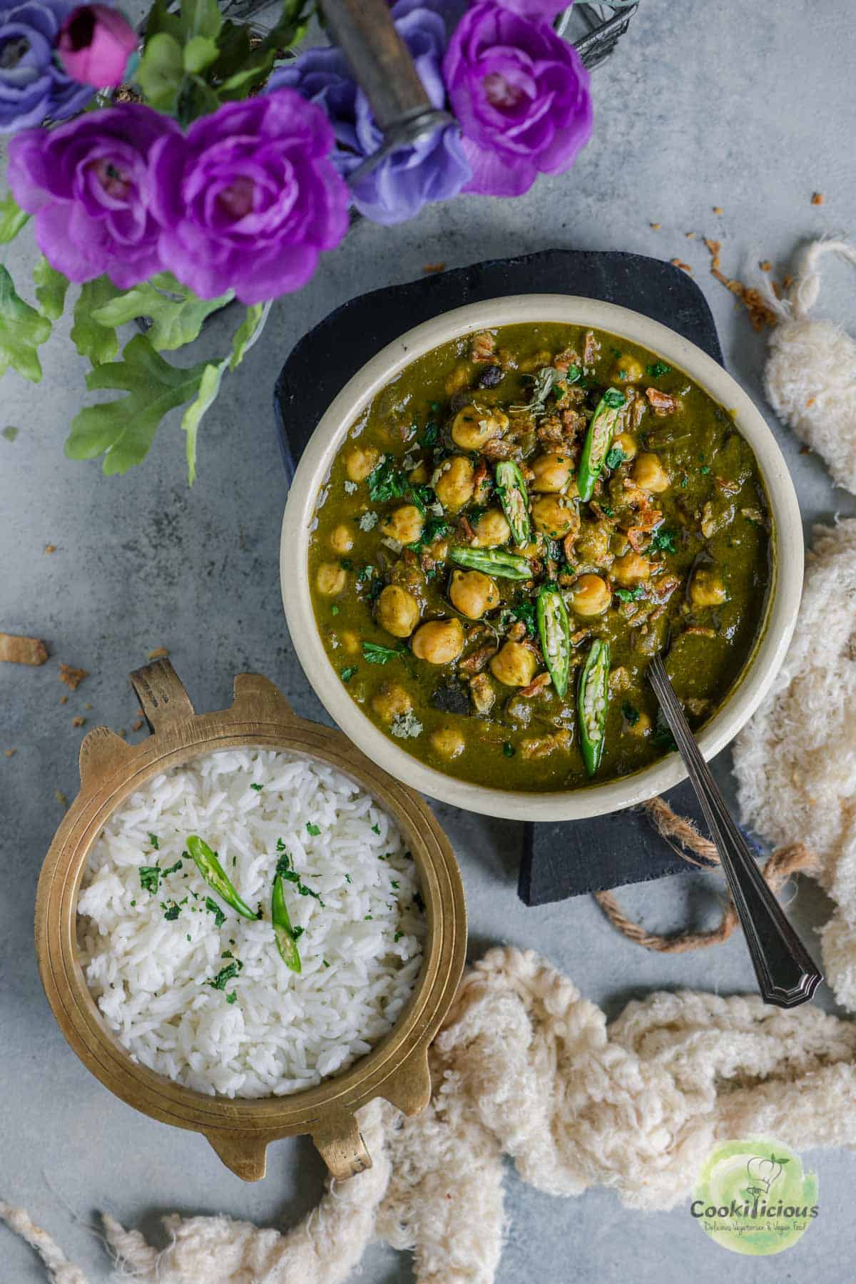 Chana Palak served with a bowl of white rice next to it