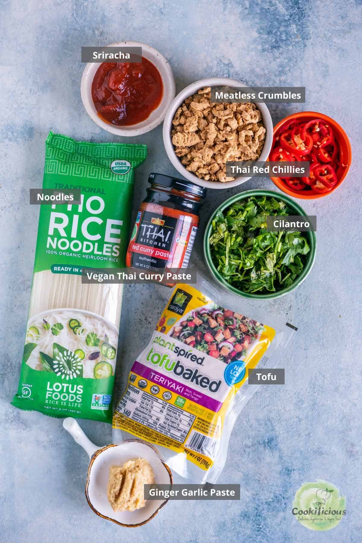 all the ingredients needed to make vegan spicy Thai noodles placed on a table with labels on them