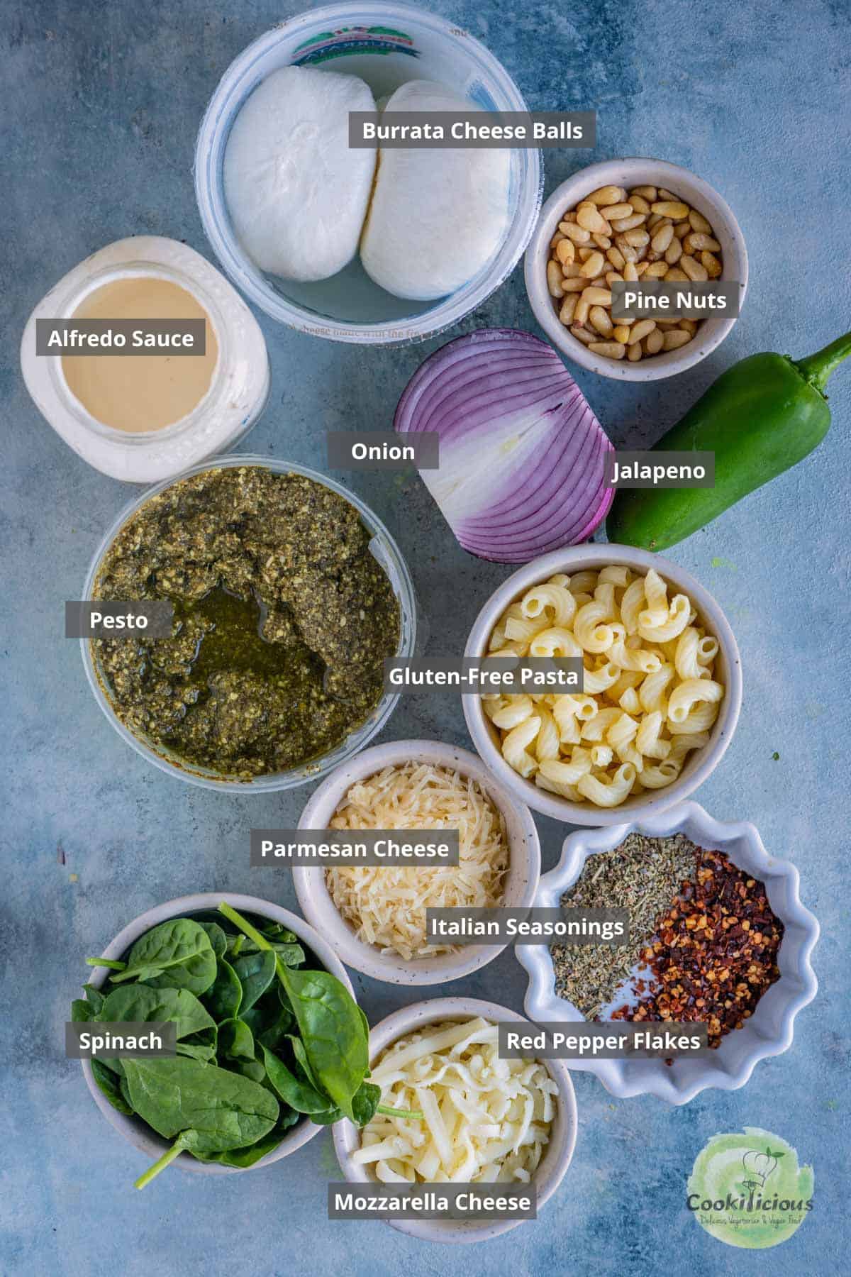 all the ingredients needed to make Creamy Pesto Pasta Bake placed on the table with labels on them