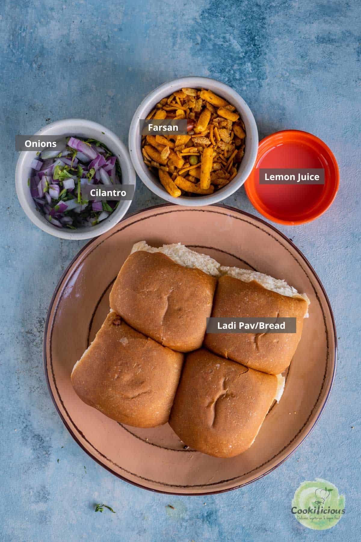all the ingredients needed to garnish misal pav placed on a table with labels on them
