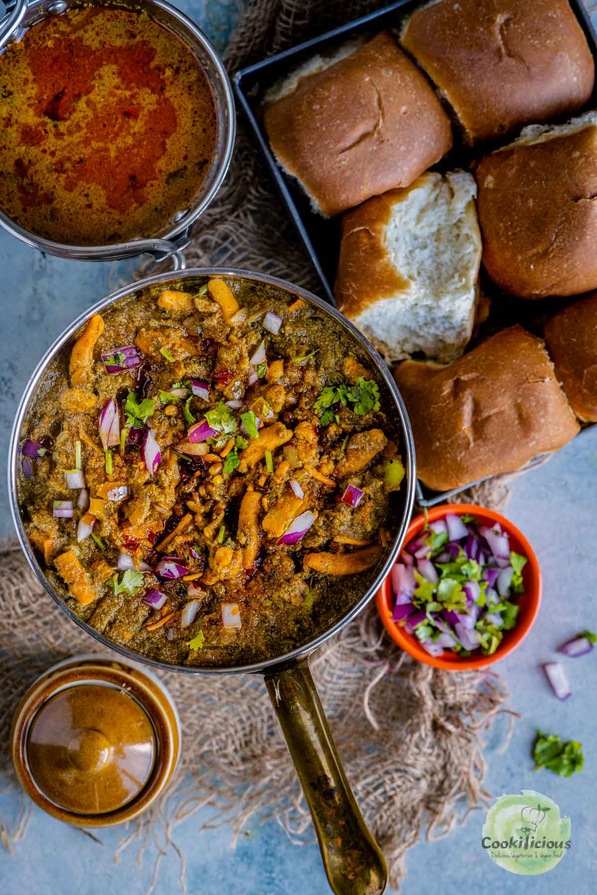 misal served in a plate with pav on the side
