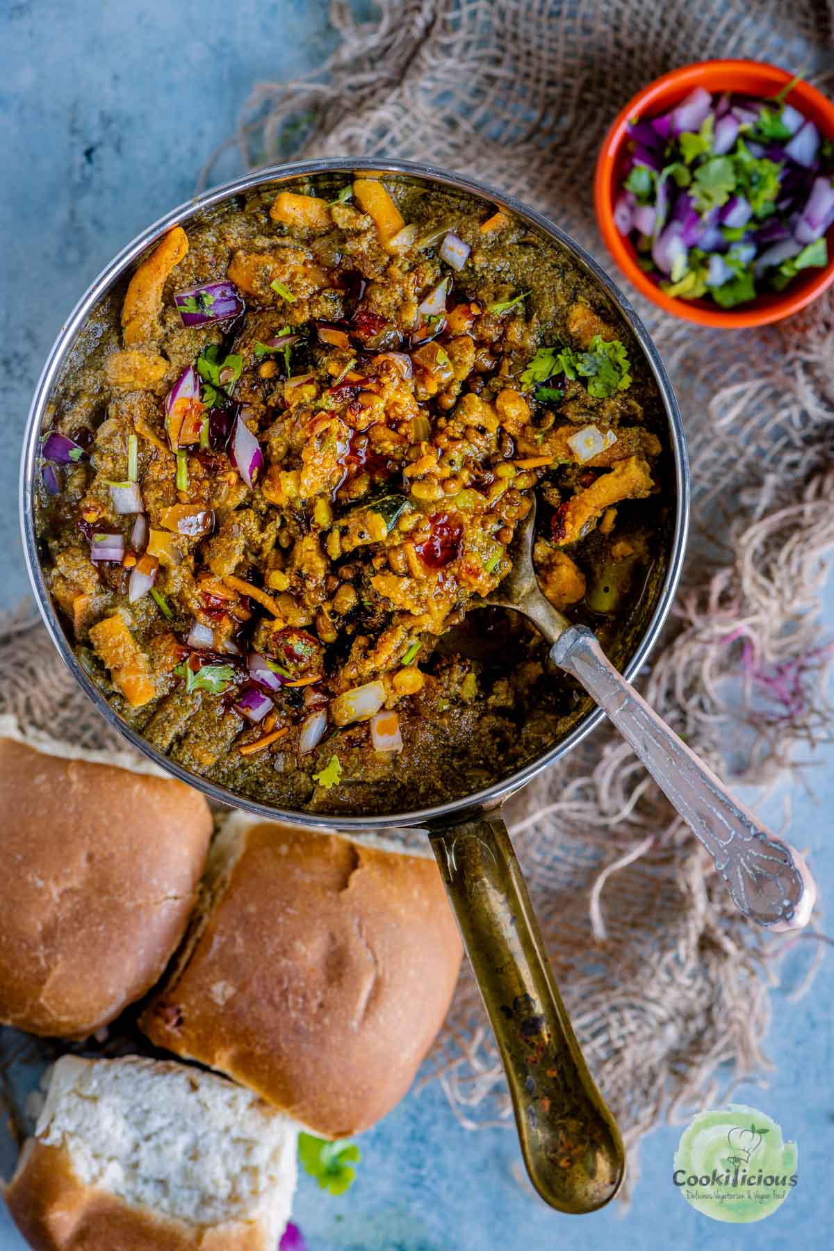 misal served in a round platter with a spoon in it