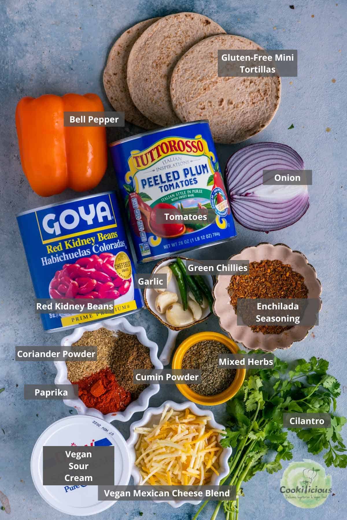 all the ingredients needed to make Vegan Enchilada Casserole placed on a table with labels on them
