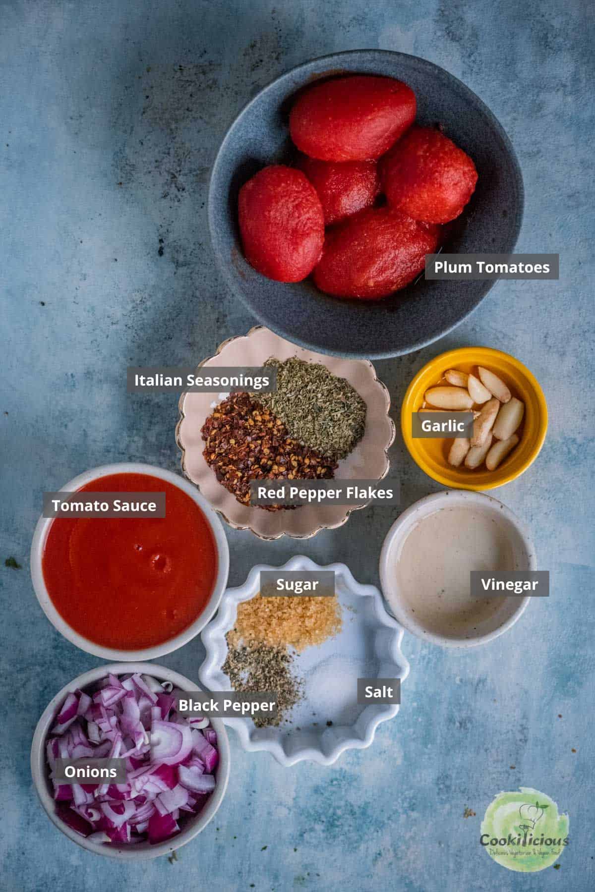 all ingredients needed to make vegan marinara sauce placed on a table with labels on them