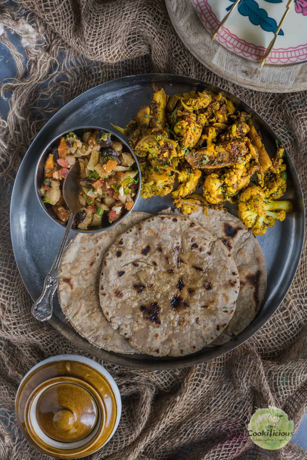An Indian platter with gluten-free roti, salad and curry.