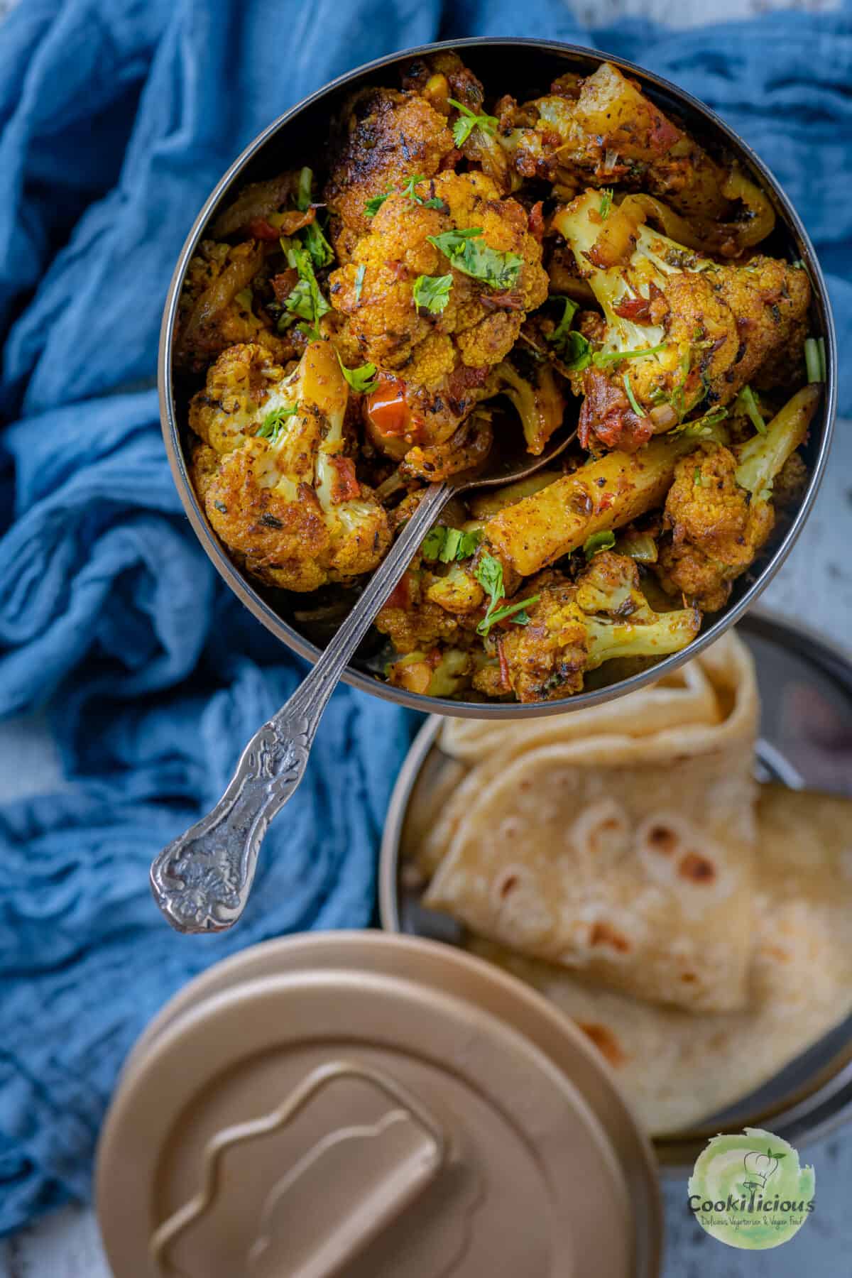 Aloo Gobi served in an Indian lunch box with chapati.