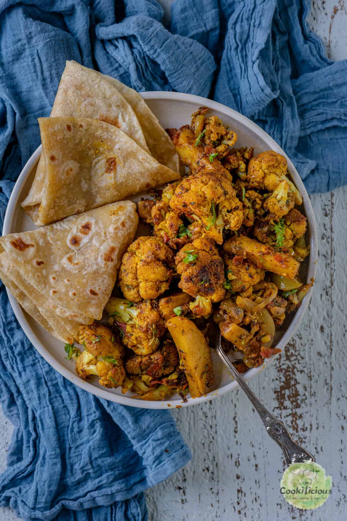 Aloo Gobi served with chapati in a plate.