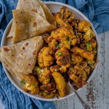 Aloo Gobi served with chapati in a plate.
