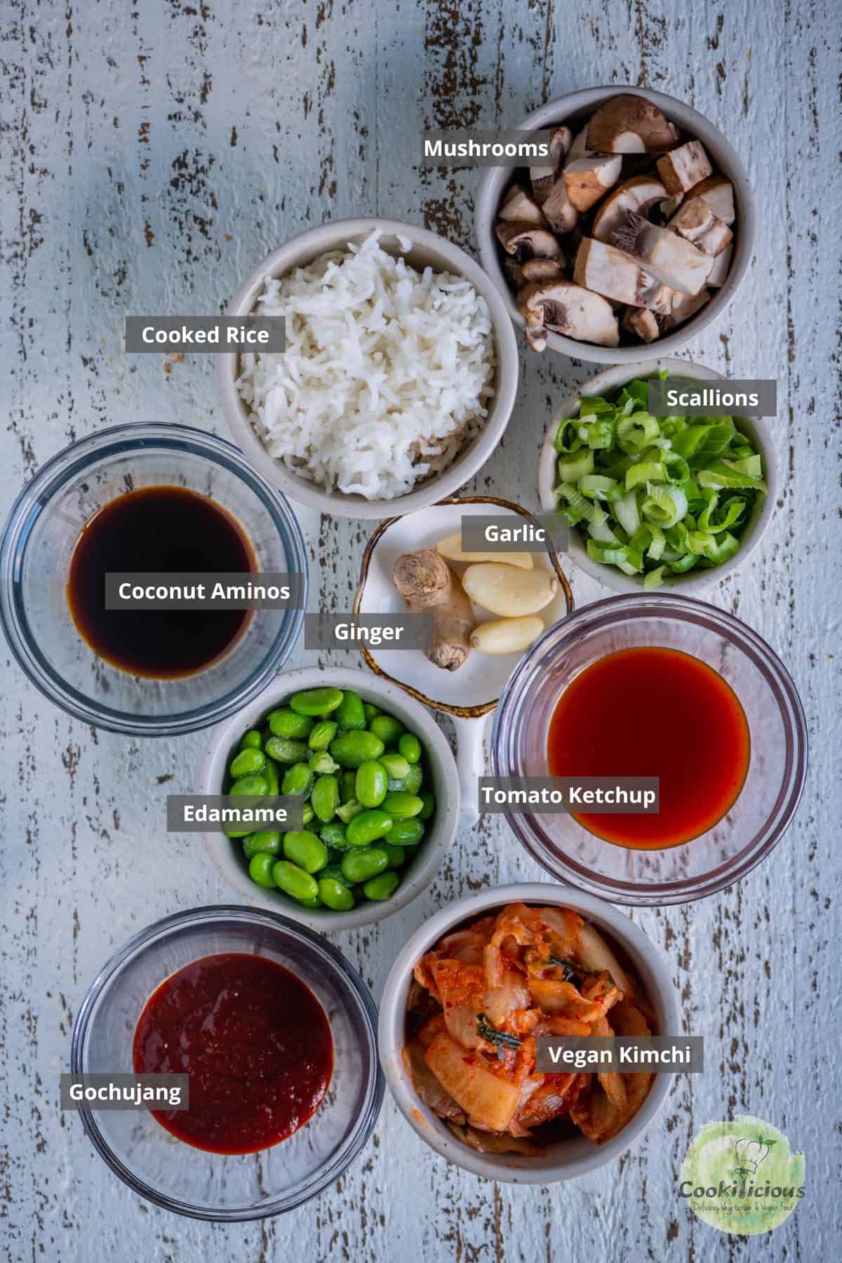 all the ingredients needed to make Korean Fried Rice are placed on a table with labels on them.