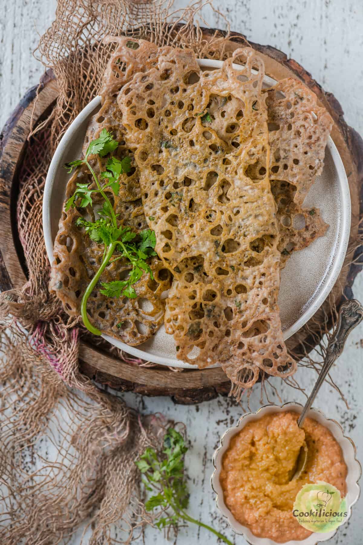 kuttu dosa served in a plate with a side of chutney.