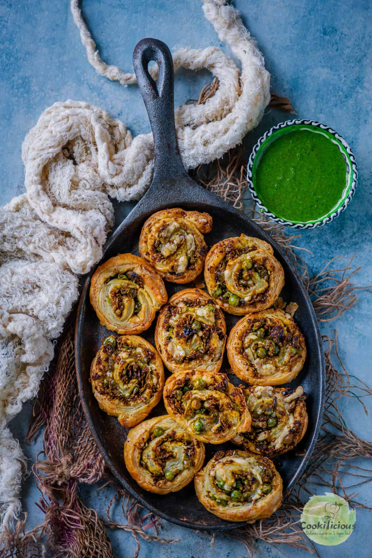 Matar Kachori Pinwheels served in a platter with a bowl of chutney on the side.