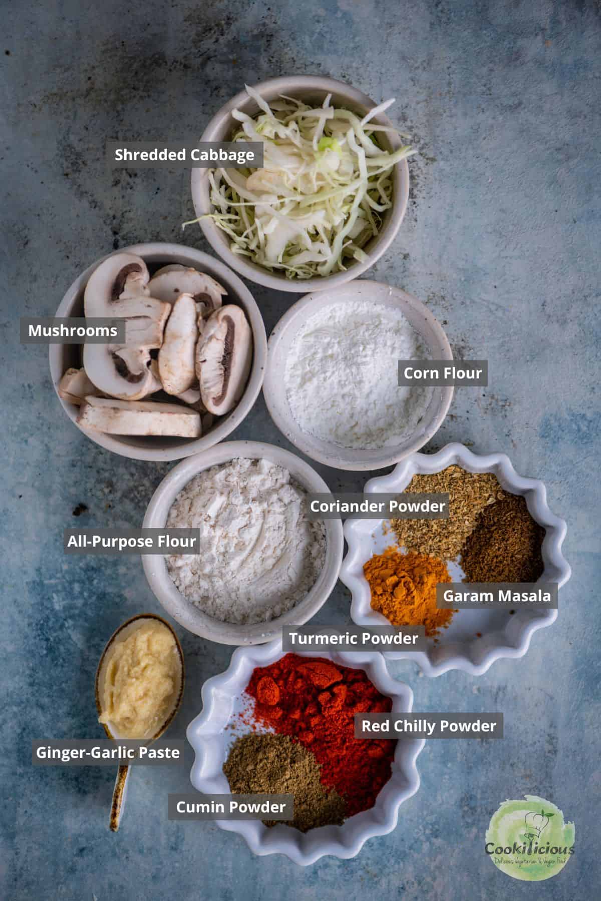 All the ingredients needed to make mushroom kalan masala placed on a table with labels on them.