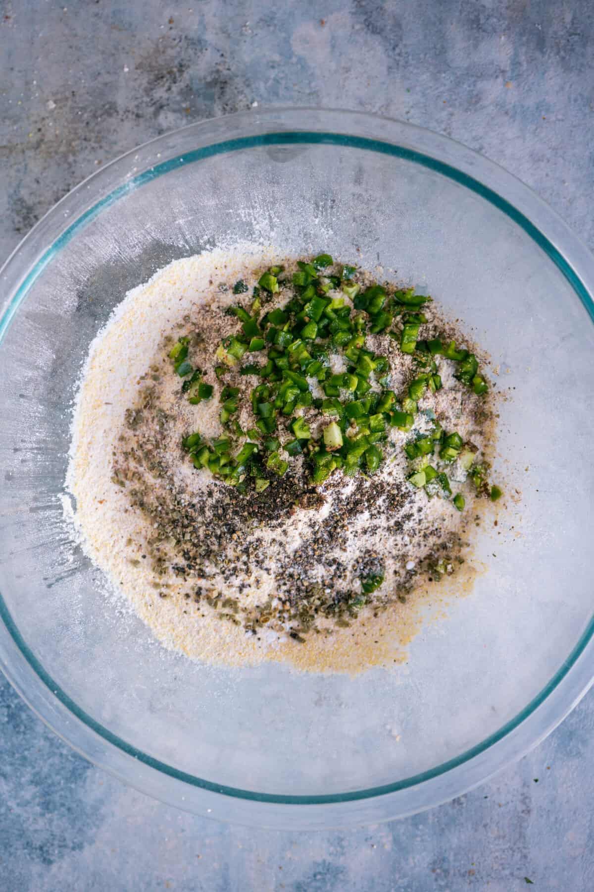 Chopped jalapeños and crushed peppercorns added to the seasoned cornbread mix.