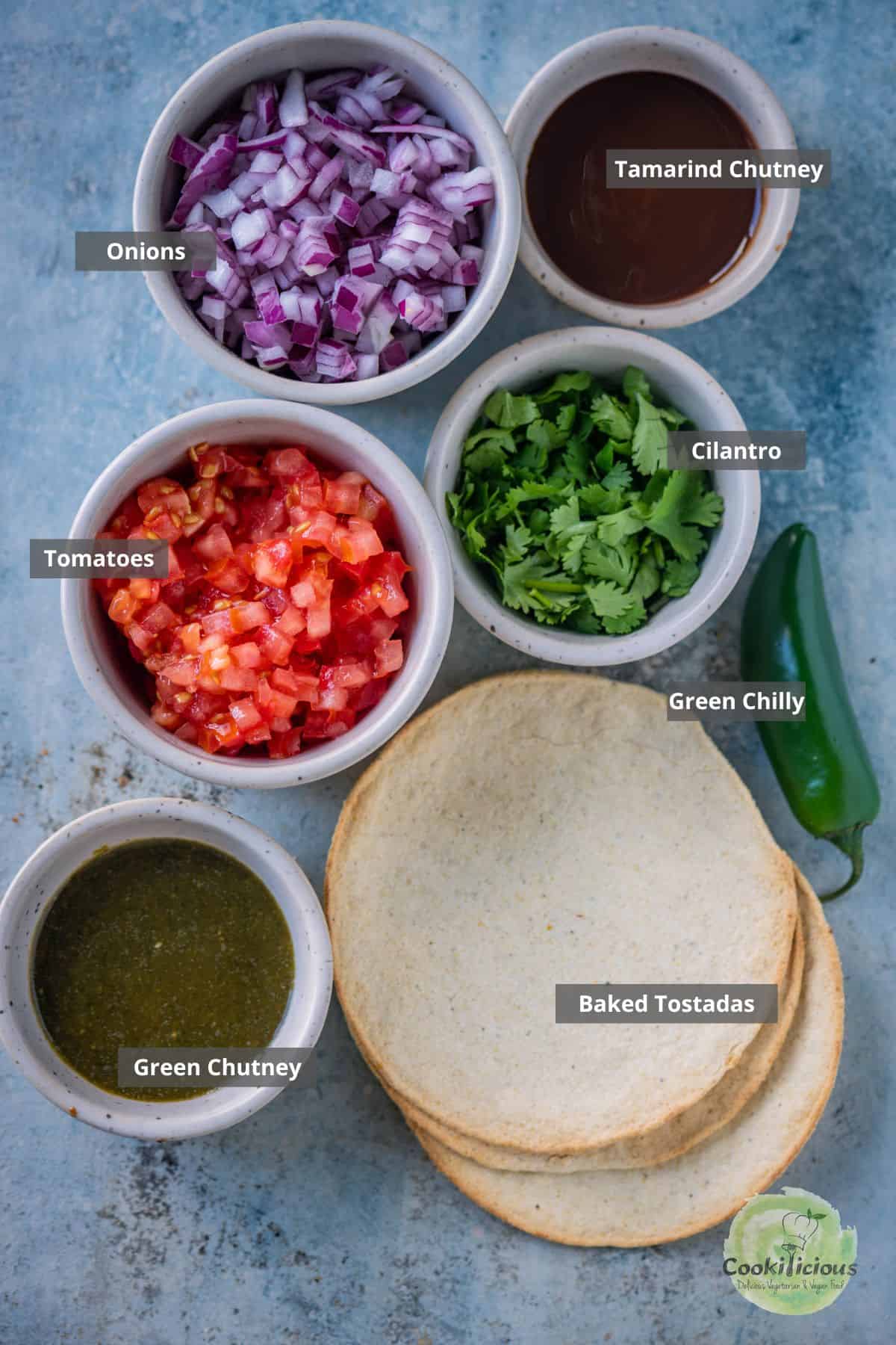 All ingredients needed to make Dal Pakwan Tostadas placed on a table with labels on them.