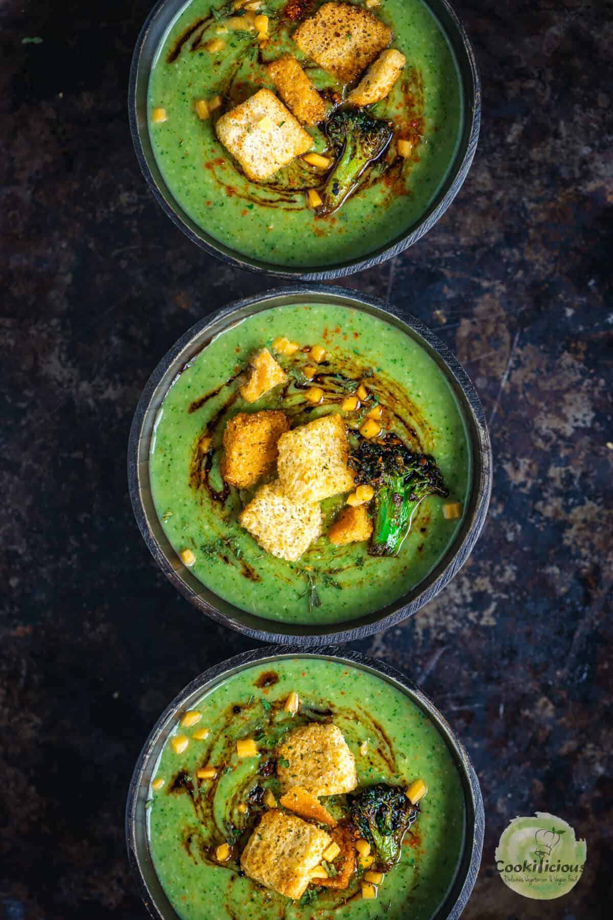 3 bowls filled with Vegan Broccoli Cheddar Soup.