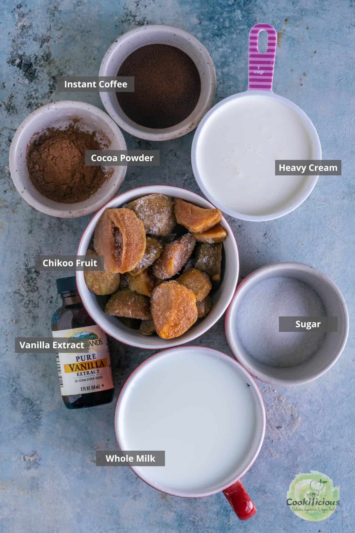 all ingredients needed to make sapota milkshake placed on a table with labels on them.