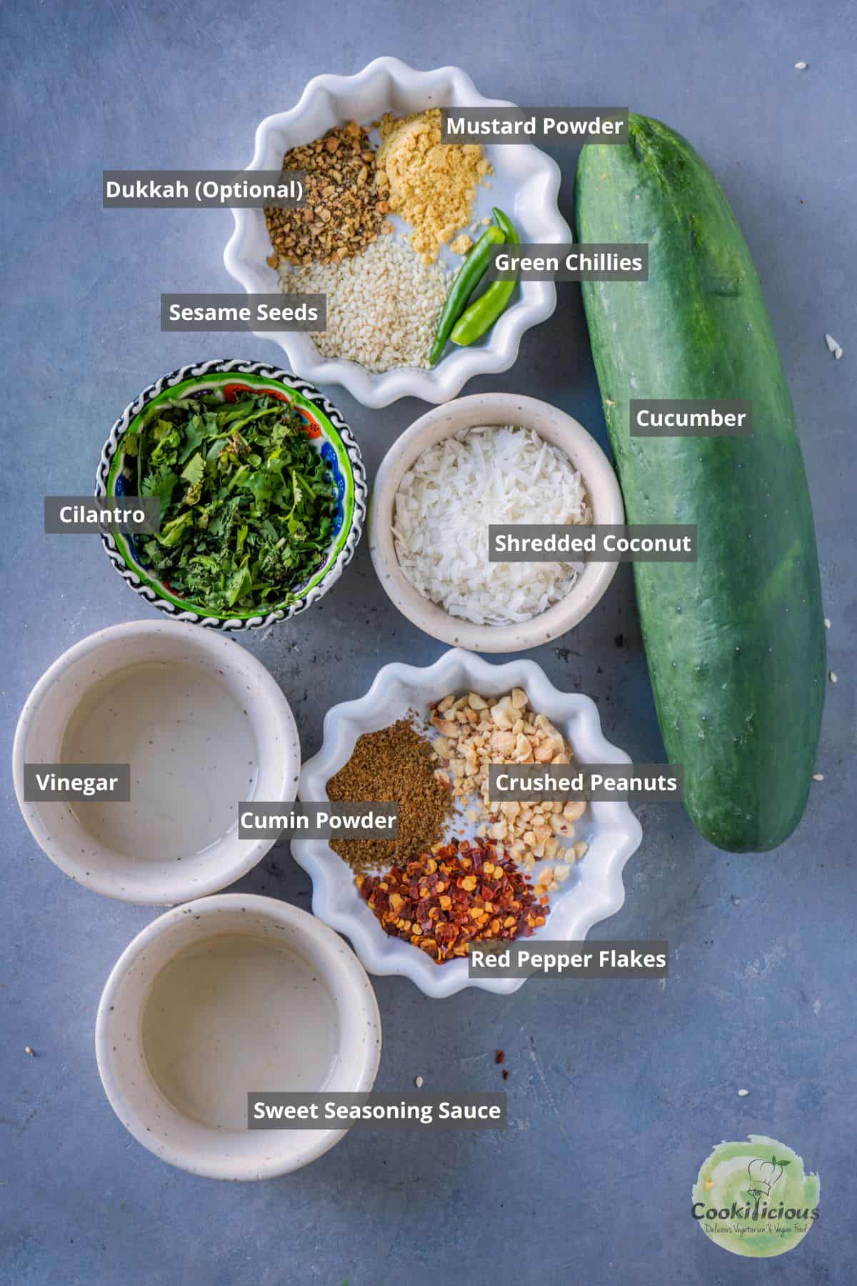 All the ingredients needed to make Spicy Asian Cucumber Salad placed on a table with labels on them.