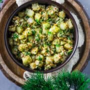 A wooden bowl filled with Spicy Asian Cucumber Salad.
