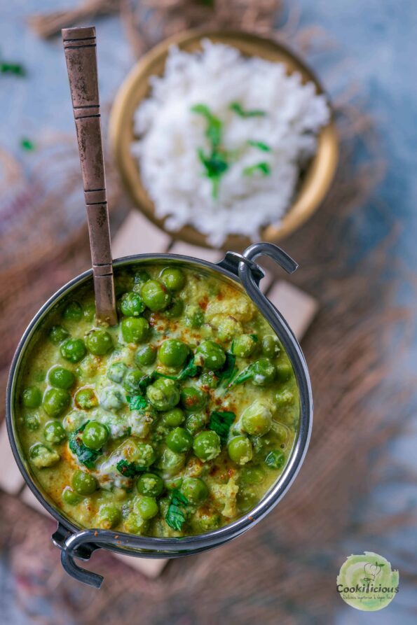 Kerala-Style Green Peas Curry served in a bowl with rice on the side.