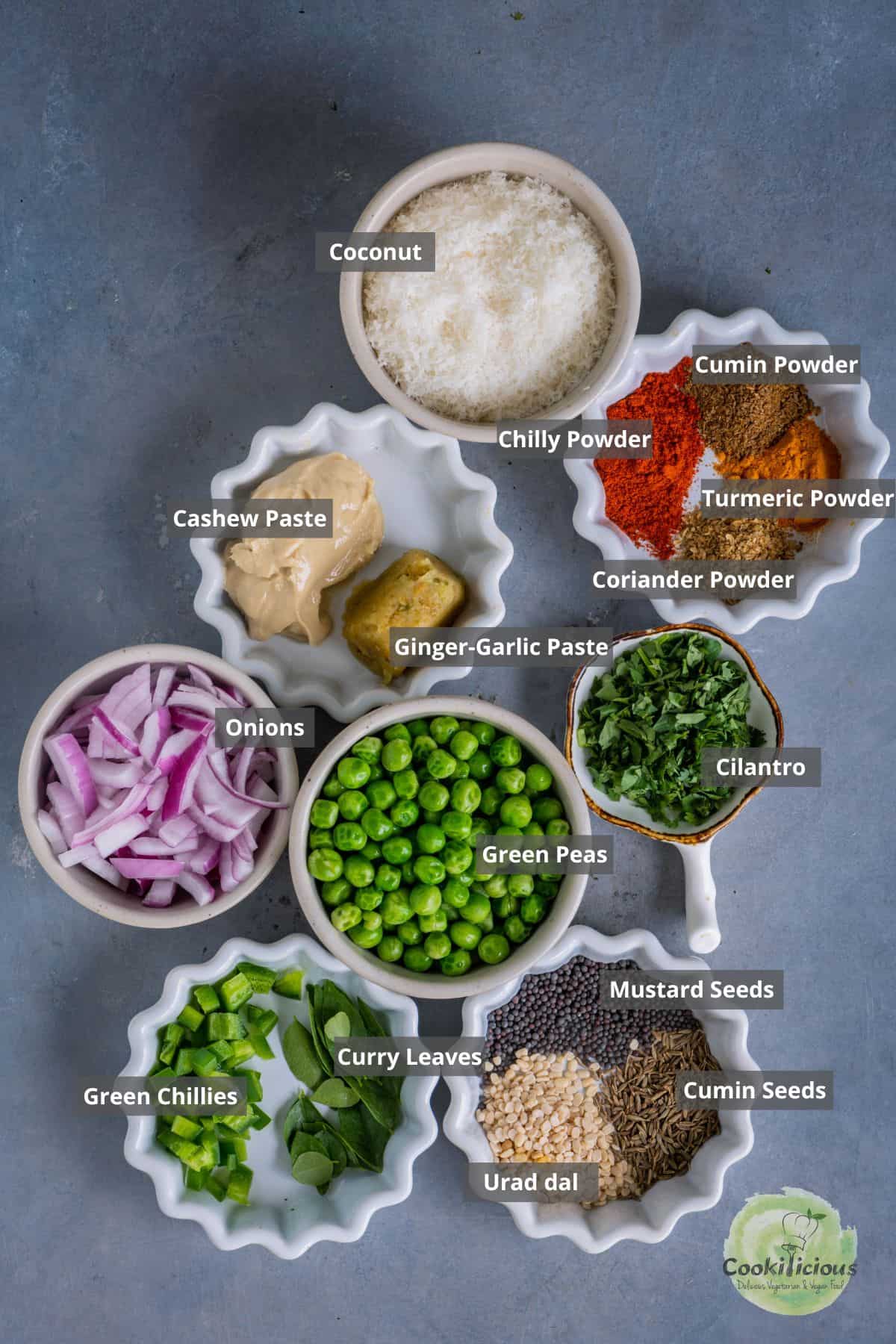 All ingredients needed to make Kerala-Style Green Peas Curry placed on a table with labels on them.