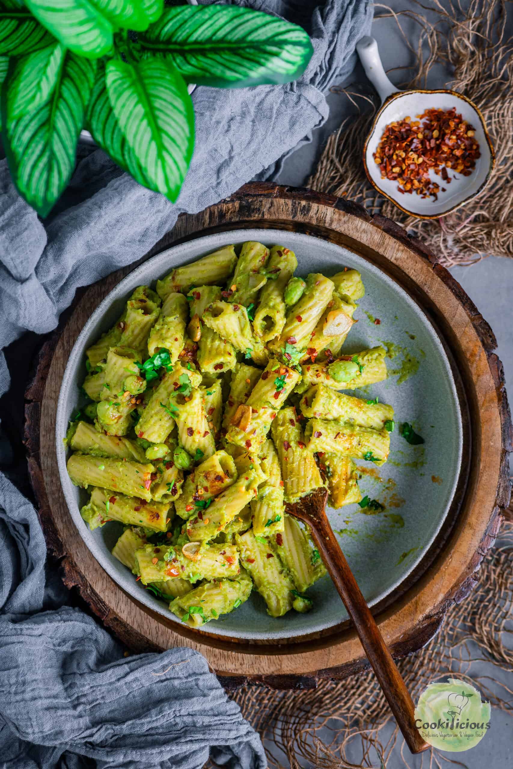 Creamy broccoli pasta served in a round plate with a fork in it.