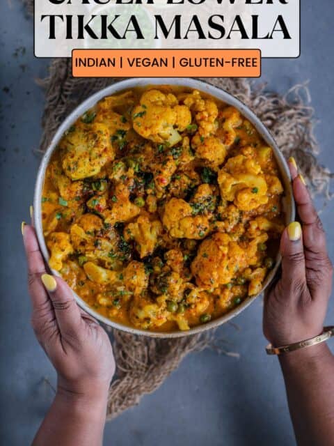 a set of hands holding a bowl of Indian Cauliflower Tikka Masala and text at the top and bottom.