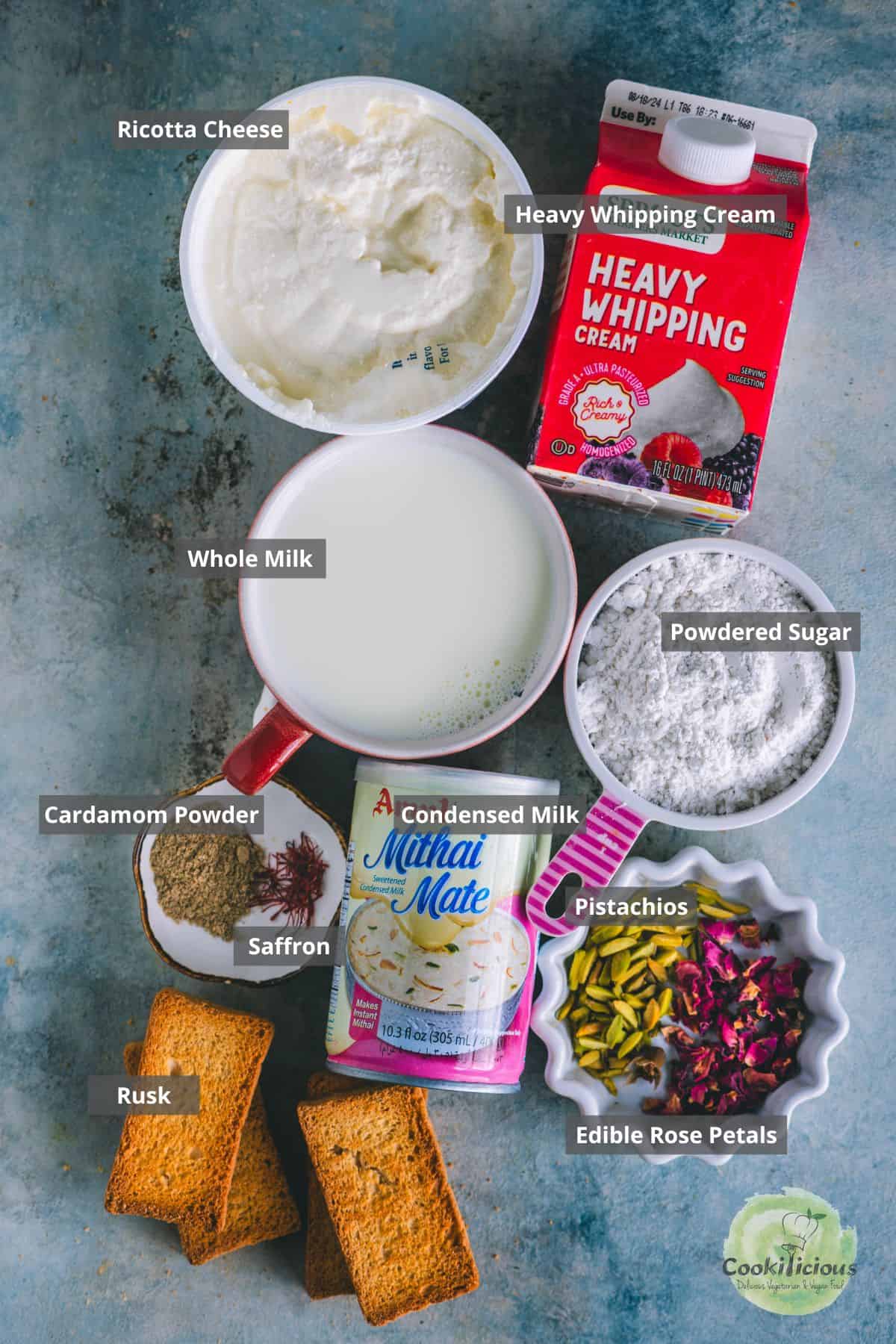 all ingredients needed to make easy, no-bake Rasmalai cake placed on a table with labels on them.