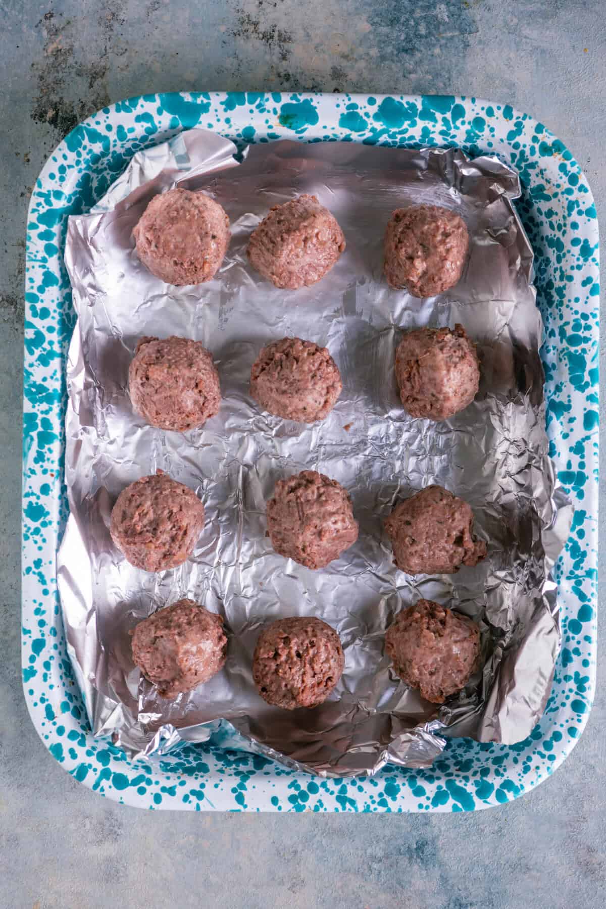 Plant-based meatballs arranged on a baking tray before baking for kofta curry.