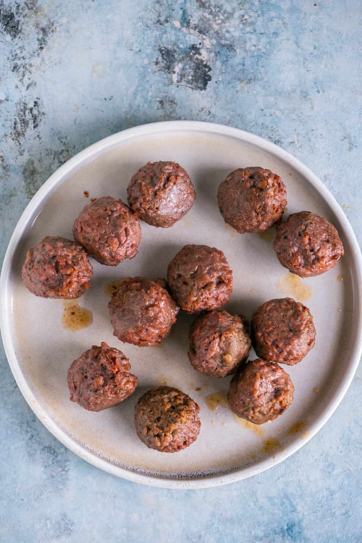 Baked vegan meatballs flipped halfway through cooking for meatball curry.