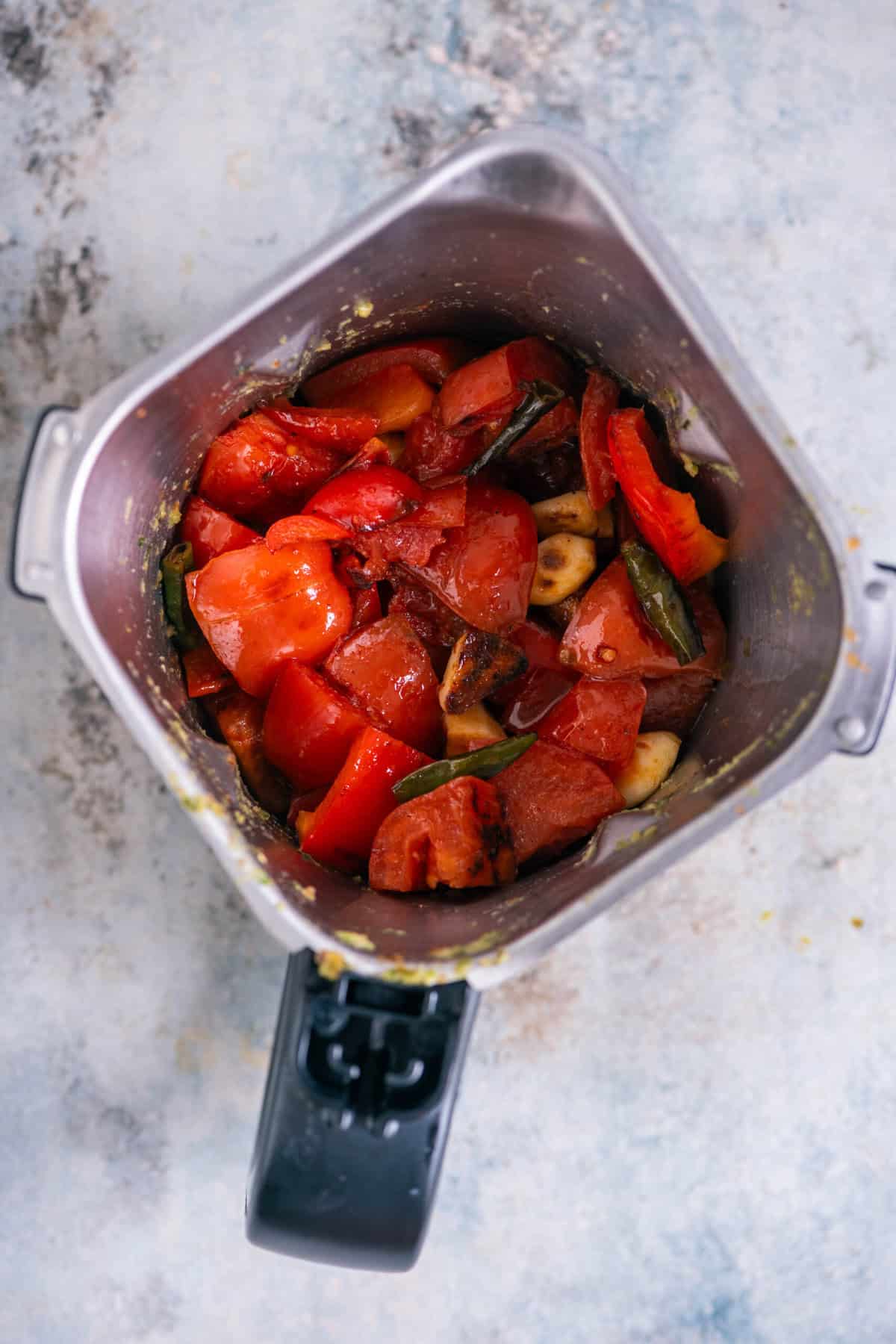 Cooled grilled vegetables transferred to a blender jar.