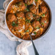 Kofta Curry with Plant-Based Meatballs served in a bowl with a spoon in it.