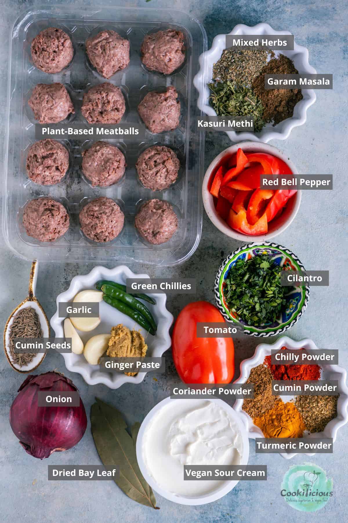 All the ingredients needed to make Kofta Curry with Plant-Based Meatballs placed on a table with labels on them.