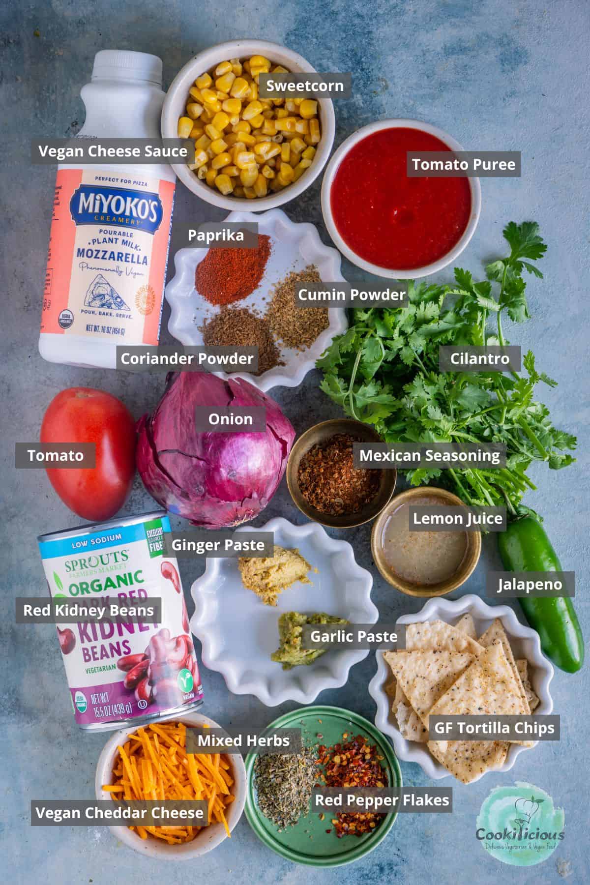 all the ingredients needed to make Vegan Loaded Nachos placed on a table with labels on them.