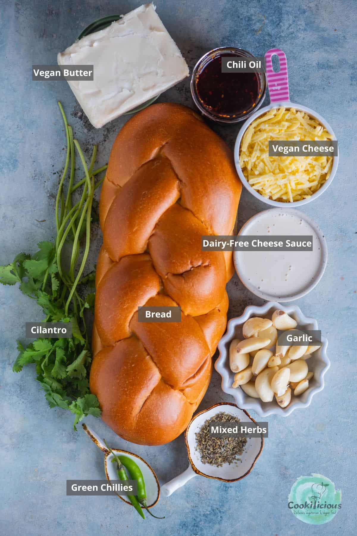 all the ingredients needed to make vegan Air Fryer Garlic Bread placed on a table with labels on them.