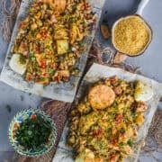 Authentic street-style Mumbai Bhel Puri served on two paper plates with Papdi.