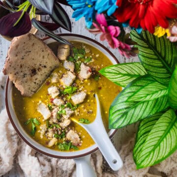 Indian Lentil Soup served in a bowl with bread.