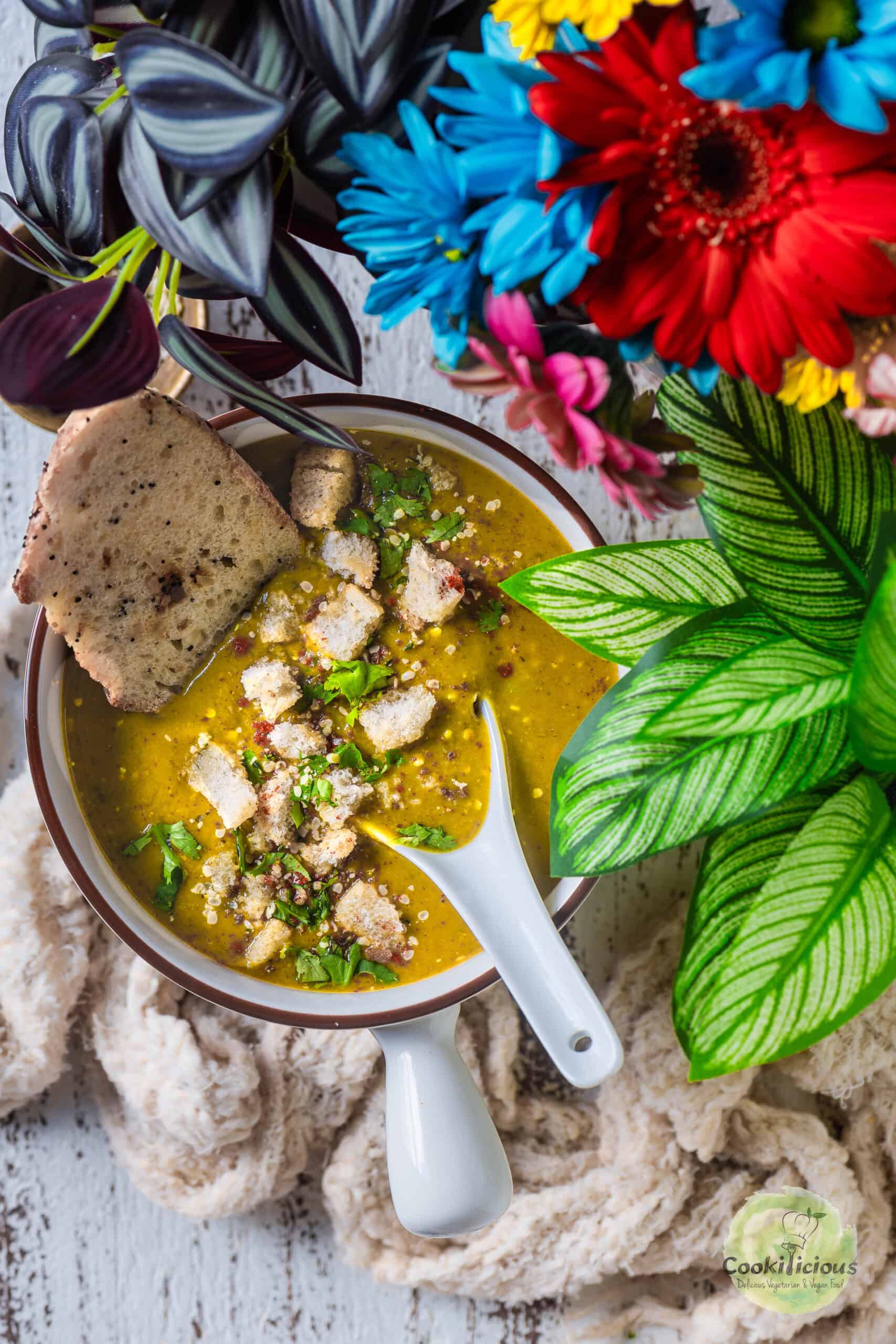 Indian Lentil Soup served in a bowl with bread.