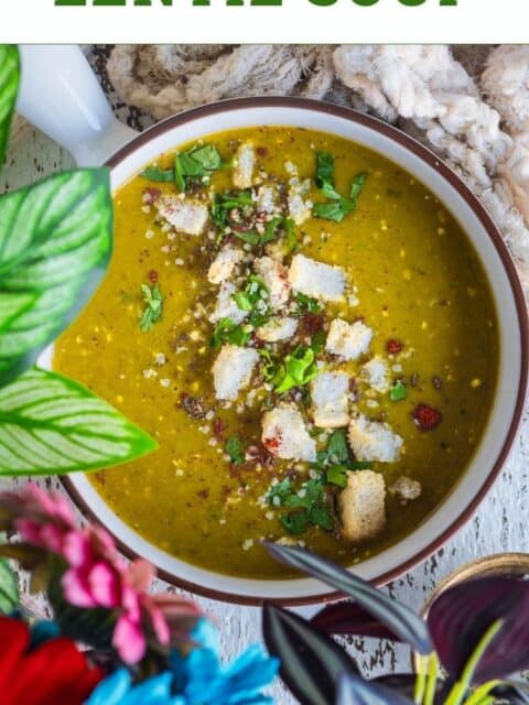 Dal Shorba served in a bowl garnished with croutons and text at the top.